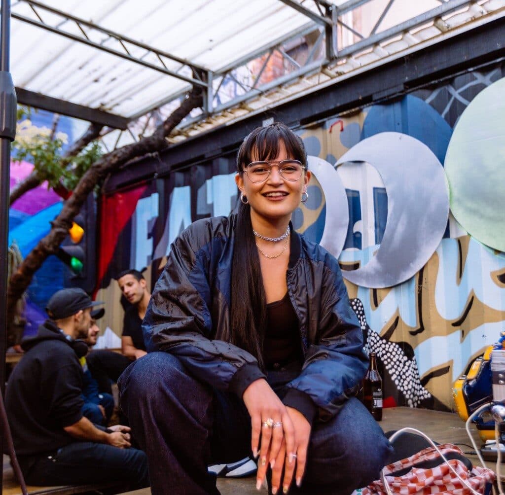 An image of Rosie Clynes squatting at a music venue.